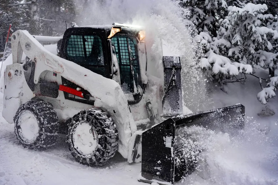 HSR loader clearing deep snow from a Duck Creek driveway