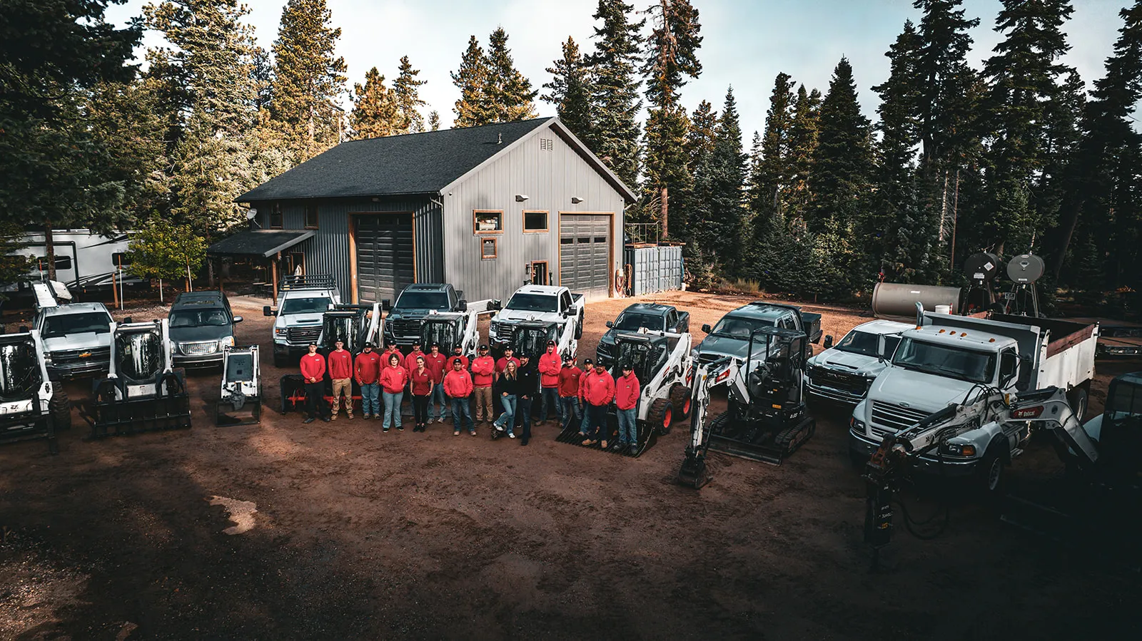 The HSR Cabin Services team gathered with their service vehicles and equipment in Duck Creek Village